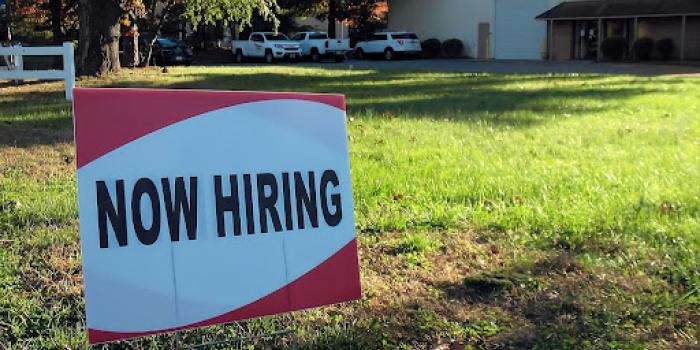sign that says now hiring