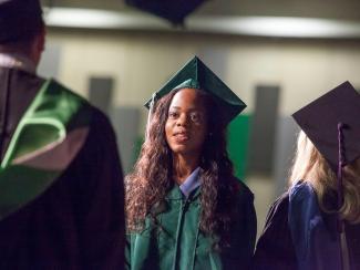 Young woman in graduation regalia