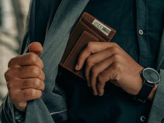 Man putting wallet in jacket pocket