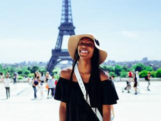 Black tourist in front of Eiffel Tower