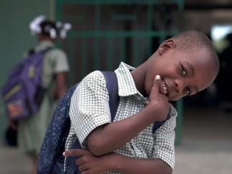 Young boy with backpack at school
