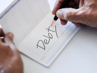 Hand writing debt on checkbook
