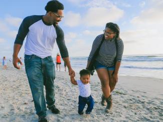 Black family walking on beach