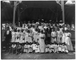 African American children with a few adults in a pavilion