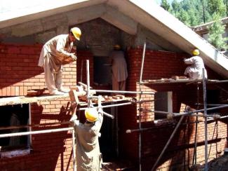 Construction workers building a house