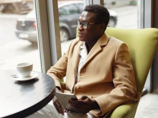 Man looking out of a window in a coffee shop