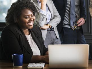 Black woman presenting on computer