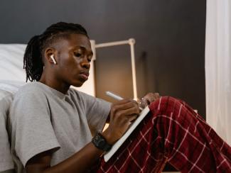 Man writing in notebook