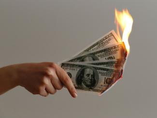 Money burning in hand