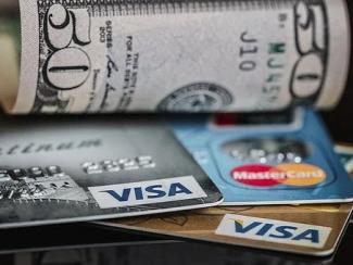 credit cards stacked with fifty dollar bill