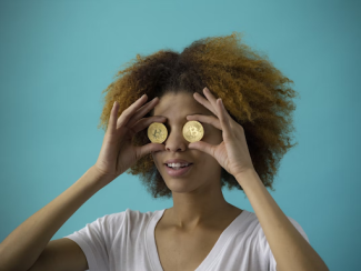 Woman covering eyes with coins