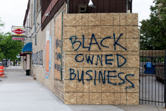 Board with "Black Owned Business" spray painted