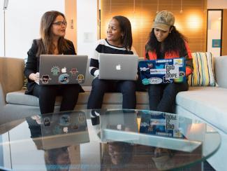 Three women meeting with laptops