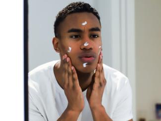 Man with skin cream on face