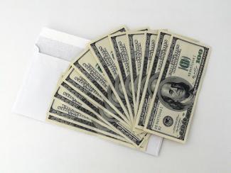 Hundreds of US dollars on letter envelope