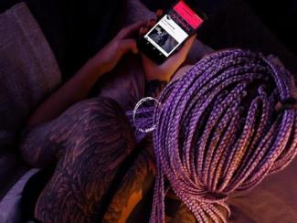 Woman with tattoos on cell phone