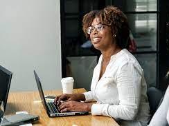 Woman using laptop at conference room table