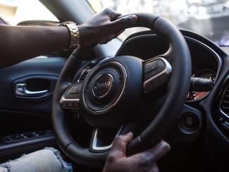 Hands on the steering wheel of car