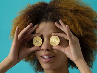 Woman holding coins over her eyes