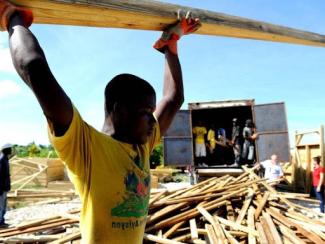 male workers preparing materials for transitional shelters