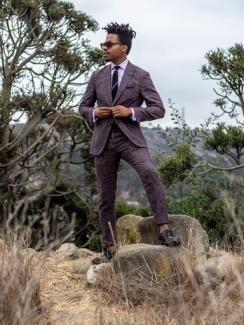 Man in a suit on a mountain top