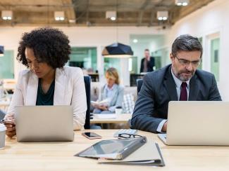People working on laptops at a table