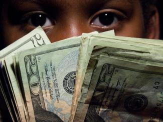 Child holding $20 Bills