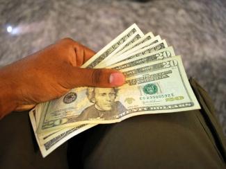 Person holding US Twenty dollar bills