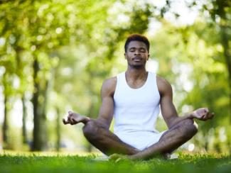 Black man in yoga pose