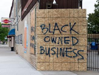 Black Owned Business spray painted on plywood