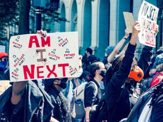 Demonstrators holding signs