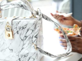 Luxury handbag on table