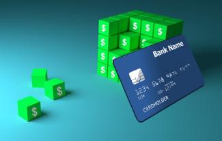 Generic credit card on top of blocks with dollar signs