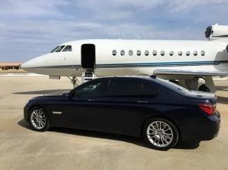 Private car parked beside luxury aircraft