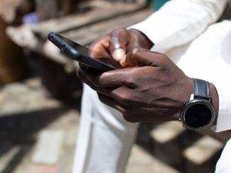 Hands holding cell phone