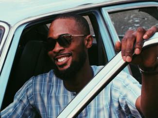 Man smiling in vintage car