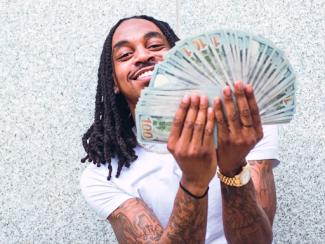 Man holding US $100 bills