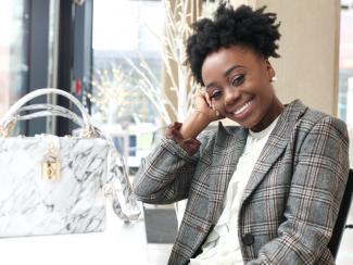 Well-dressed woman sitting at table