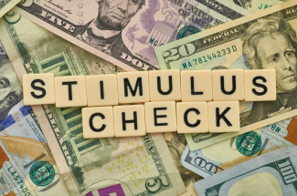 Cash pile with words stimulus check above