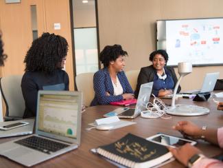 Business women at conference table 