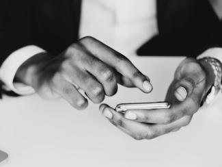 Hands holding a phone texting