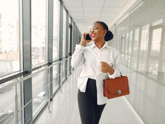 black woman smiling with phone to the ear
