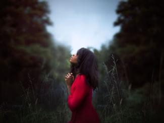 black woman standing outside in a forest