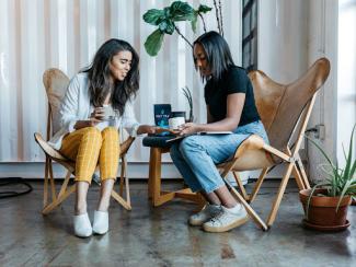 two women setting together