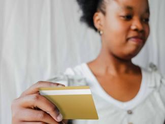 black woman holding a credit card
