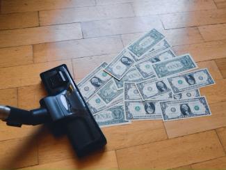 vacuum sucking up dollar bills 