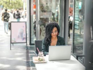 woman sitting outside using laptop 