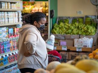 woman in grocery story looking at produce