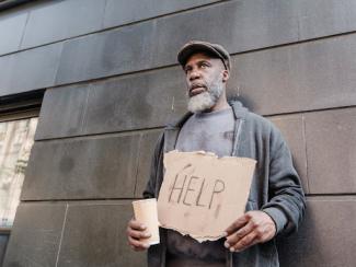 man holding sign that says help