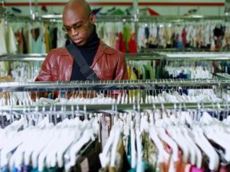 black man browsing a clothing rack
